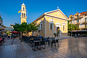 View of restaurant and Church of Agios Spiridon in Argostoli, capital of Cephalonia, Argostolion, Kefalonia, Ionian Islands, Greek Islands, Greece, Europe\n