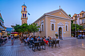 View of restaurant and Church of Agios Spiridon in Argostoli at dusk, Argostolion, Kefalonia, Ionian Islands, Greek Islands, Greece, Europe\n