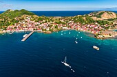 Guadeloupe, Les Saintes, Terre de Haut, the bay of the town of Terre de Haut, listed by UNESCO among the 10 most beautiful bays in the world, Basse Terre background (aerial view)\n