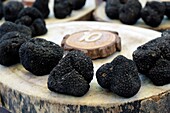 France, Vaucluse, Vaison la Romaine, street, market on Tuesday morning in summer, etal of a producer of truffles, summer truffle (Tuber aestivum)\n