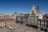 France, Nord, Lille, Place du General De Gaulle or Grand Place, facade of the Voix du Nord building with a drawing as part of the Lille 3000 Eldorado exhibition next to the Théâtre du Nord and in front of the old stock exchange\n