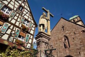 France, Haut Rhin, Kaysersberg, Place Jean Ittel, Sainte Croix church, portal dated 13th century, fountain Emperor Constantine 1521, half-timbered house\n