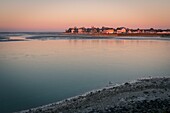 France, Somme, Somme Bay, Le Crotoy, The Somme Bay by cold weather in Winter, view of Le Crotoy in the early morning with frozen water and ice on the ground\n