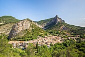 France, Hautes-Alpes, Regional Natural Park of Baronnies Provençal, Orpierre, the village surrounded by cliffs, climbing site cliff Castle on the left and the rock of Quiquillon (1025 m) in the background\n