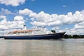 France, Seine Maritime, Heurteauville, Armada 2019, Marco Polo, cruise ship, sailing on the Seine River, in front of Jumieges Abbey\n