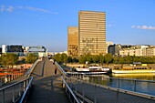 France, Paris, the banks of the Seine river, Bibliotheque Nationale de France (National Library of France) by architect Dominique Perrault and the Simone de Beauvoir footbridge by architect Dietmar Feichtinger\n