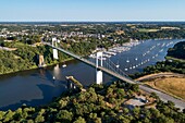 France, Morbihan, La Roche Bernard, suspended bridge over Vilaine river and the marina (aerial view)\n