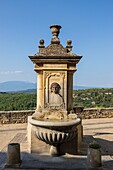 France, Vaucluse, Venasque, labeled the Most Beautiful Villages of France, fountain Place de la Planette, Mont Ventoux in the background\n