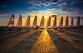 France, Morbihan, Saint Pierre Quiberon, alignment of sand yachts at sunset\n