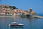 France, Pyrenees Orientales, Collioure, panorama on the beach of Boramar with the church of Notre Dame des Anges of the 17th century and a boat in the foreground\n