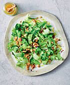 Broccoli salad with salted cashew nuts and chili pepper flakes