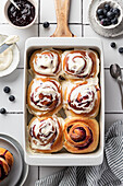 Blueberry cinnamon buns made from yeast dough with icing sugar