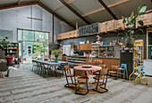 Spacious room with café corner, tables and high ceiling