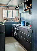 Compact modern kitchen with black cabinets