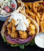 Cracked lobster gyro Served with a Greek salad and tzatziki