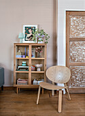 Display cabinet with decoration, wooden chair and wooden door with inlays