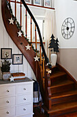 Hallway decorated for Christmas with old wooden staircase