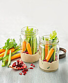 Vegetable sticks with hummus and pomegranate dip