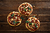 Mini lahmacun pizza with ground lamb, feta cheese and olives