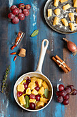 Ricotta and carrot gnocchi with grapes, chilies and shallots