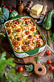 Vegetable casserole with grainy cream cheese, courgettes and tomatoes