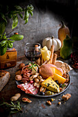 Snack board with cheese, salami, grissini and nuts