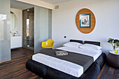 Guest bedroom with ensuite bathroom behind frosted glass doors