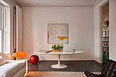 White table in living room with white walls and stucco ceiling