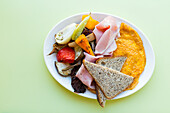 Cheese omelette with brown bread, vegetables and cooked ham