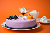 Purple Halloween cake with spooky decoration