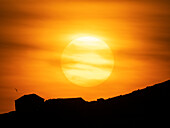 Setting Sun over a barn