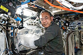 Japanese astronaut Satoshi Furukawa working in lab