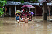 People walking through floodwater, Satkania Upazila, Bangladesh