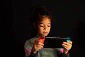 Girl playing with a games console