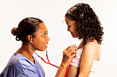 Healthcare professional assessing girl