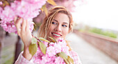 Woman admiring cherry blossom