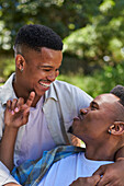 Young gay male couple hugging