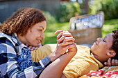 Happy lesbian couple on picnic blanket