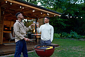 Young gay male couple enjoying barbecue