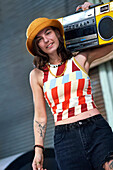 Young woman holding boom box