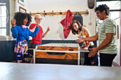 Young friends playing foosball