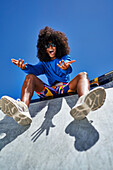 Young woman gesturing on sports ramp