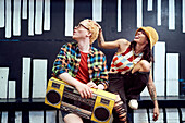 Playful young couple with boom box