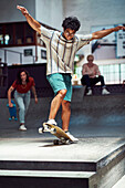 Young man skateboarding on sports ramp