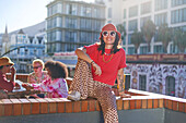 Young woman on sunny urban balcony