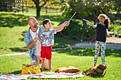 Family playing with bubbles in sunny park