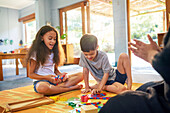 Sister and brother with Down syndrome playing with toys