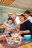 Family baking together in kitchen