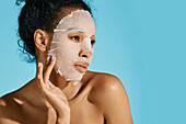 Woman using sheet mask