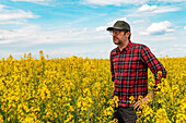 Farmer standing in rapeseed field